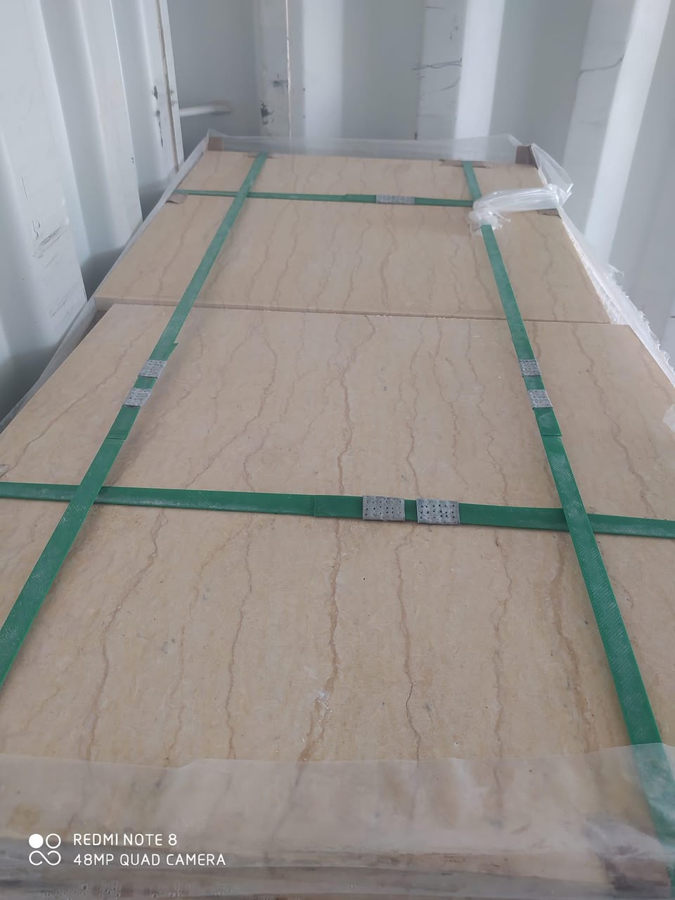 Wooden pallet with tiles tied and edge-protected